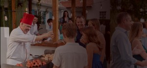 a group of people standing around a barbeque