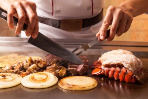 a person cooking food on a grill