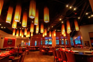 a restaurant with many lights from the ceiling