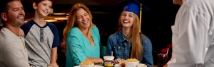 a woman and a woman smiling at a table with food